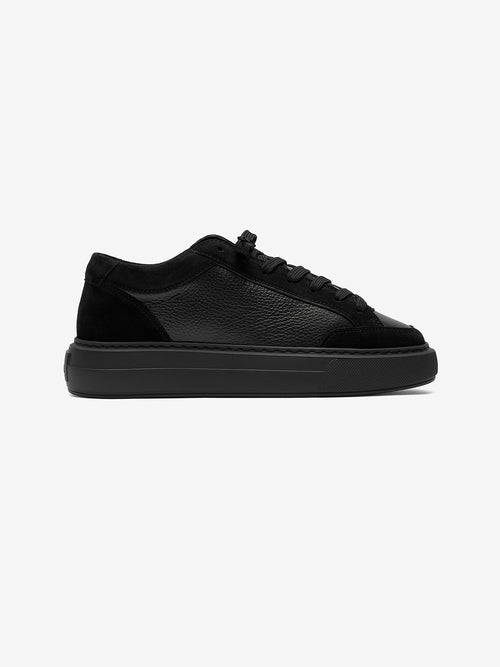 Black smart trainer on a white background
